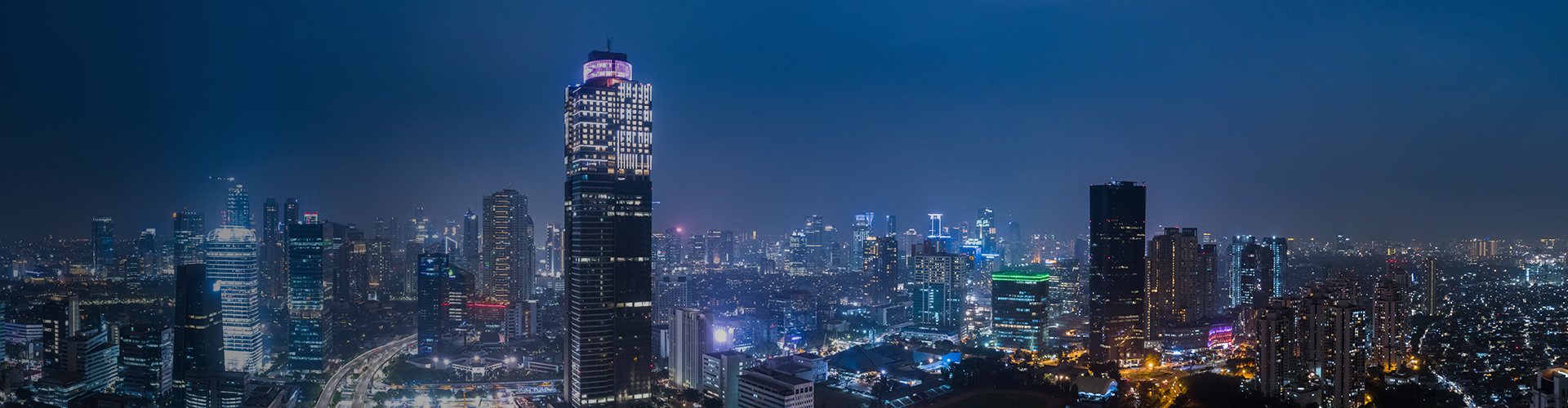Glowing city lights at night in Indonesian city, ideal for web hosting.