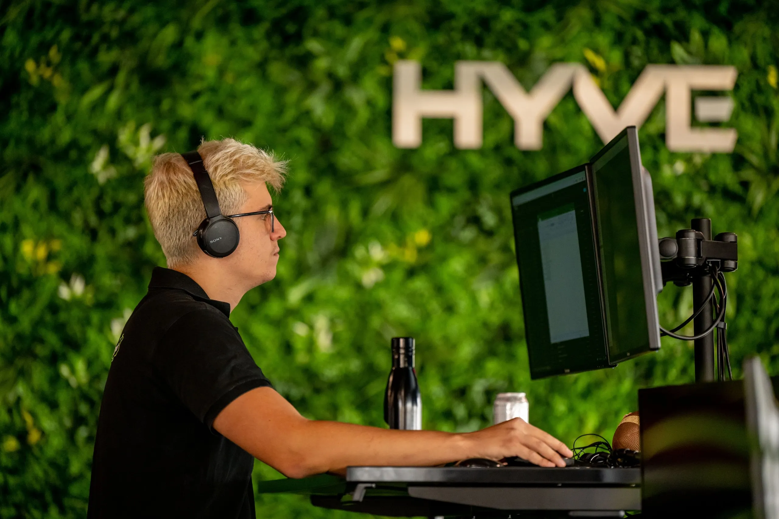 Colleague working in front of the Hyve living wall