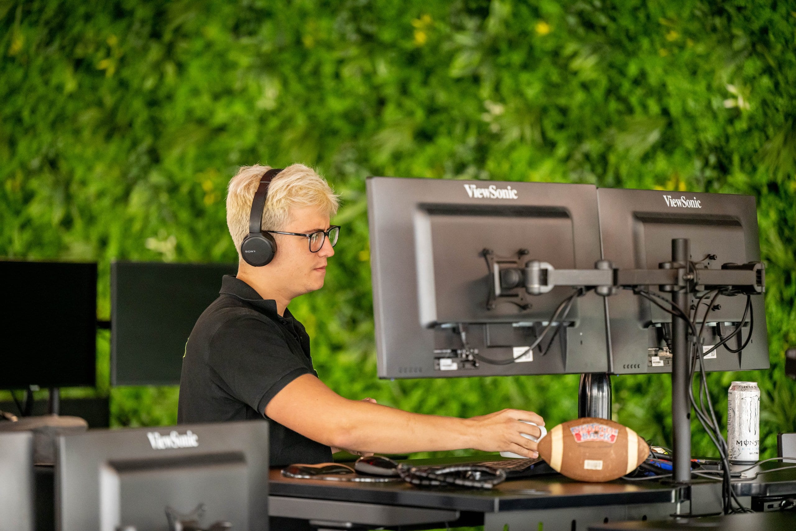 Colleague at a desk in front of a living wall