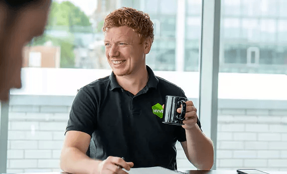 Hyve colleague holding a mug in an office