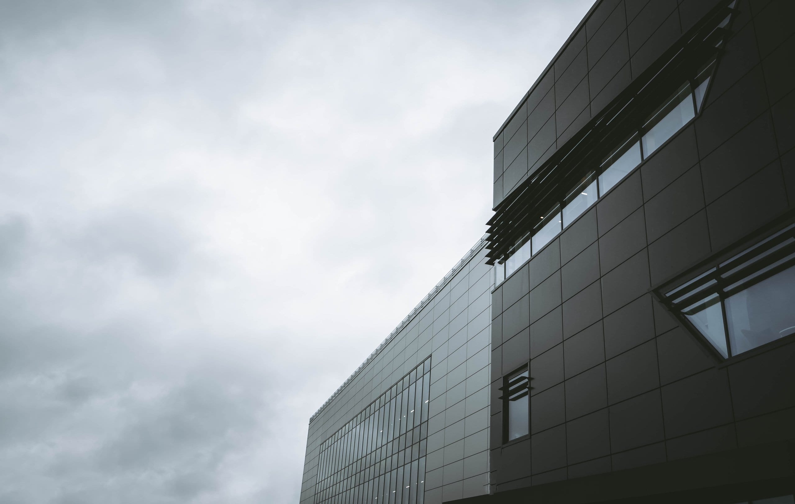 Modern office building against a bright sky