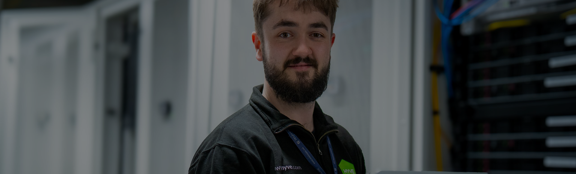 Hyve engineer holding a laptop in a data centre