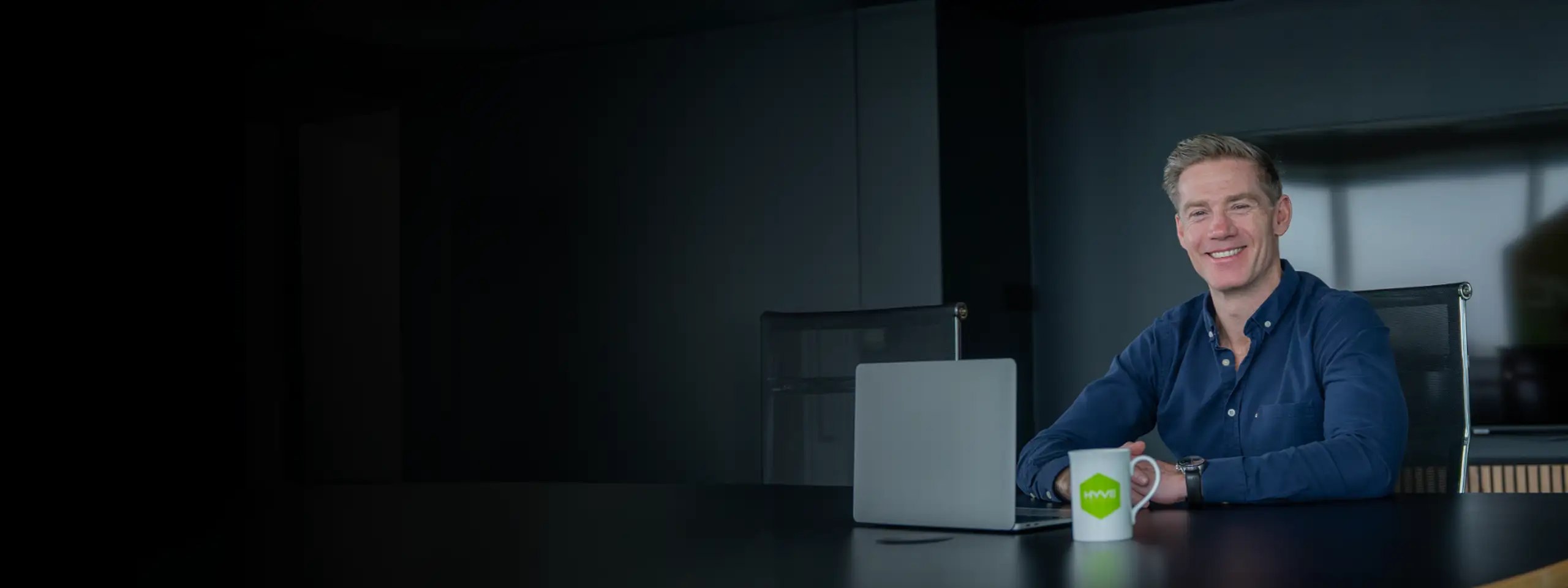 Professional in an office using a laptop