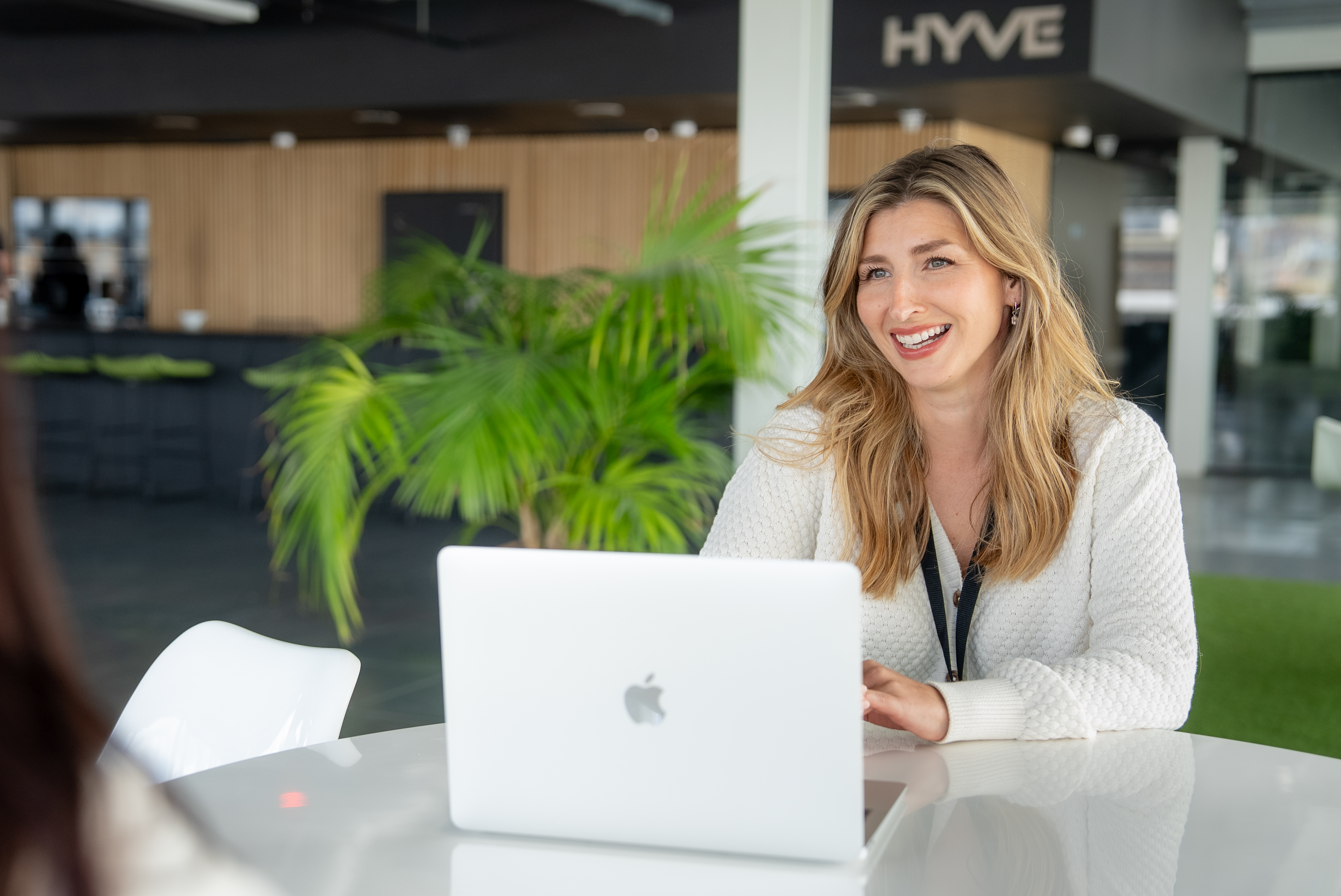 Hyve colleague smiling at a meeting table