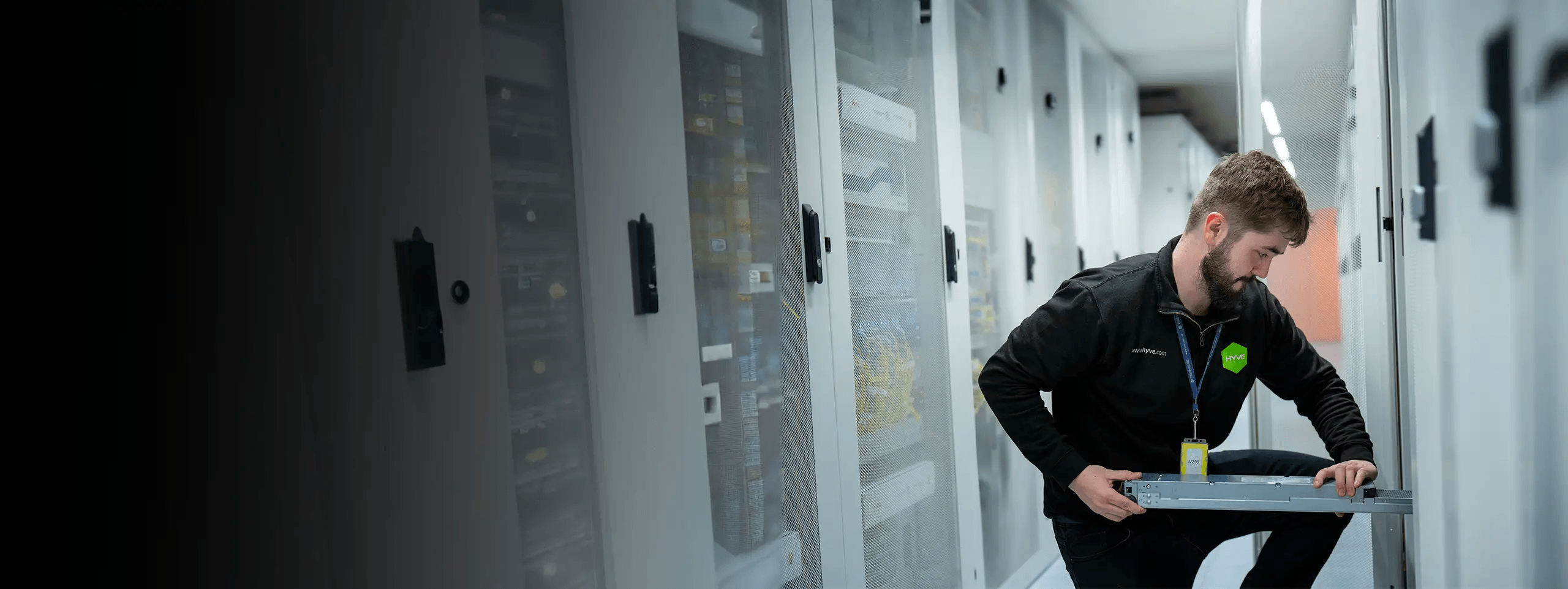 Hyve engineer installing a server in a data centre aisle