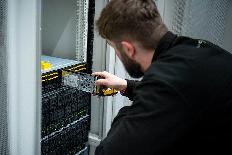 Engineer installing a server drive