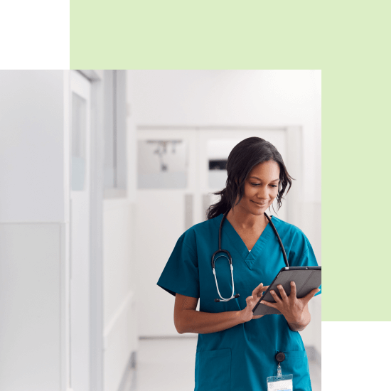Nurse looking at tablet in hospital with green border